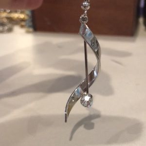 Silver colored dangle earrings with  rhinestone